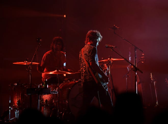 The Raconteurs play, Patrick Keeler on drums, left, and Brendan Benson on guitar.