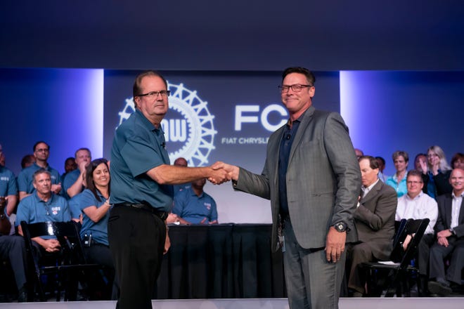 Gary Jones, president of the UAW, left, and Mark Stewart,  chief operating officer for Fiat Chrysler in North America, exchanged the ceremonial handshake marking the beginning of contract negotiations Tuesday in Auburn Hills.