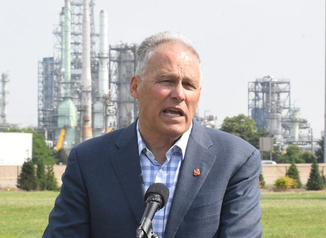 Washington Governor and Democratic presidential candidate Jay Inslee holds a press conference to introduce his "Community Climate Justice" plan across the highway from the Marathon Oil refinery, in Detroit, Michigan on July 29, 2019.