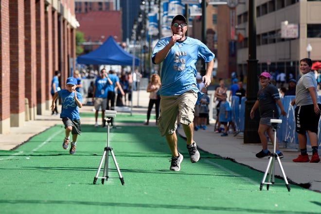 Brady Hughes, 8, of Rochester Hills, left, races against Scott Bancroft of Jackson during Lions Family Fest outside of Ford Field on Friday in Detroit.