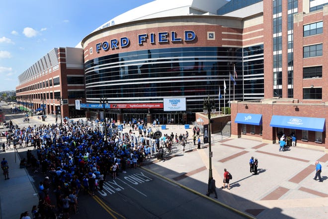 Fans line up outside Ford Field for Lions Family Fest on Friday evening.