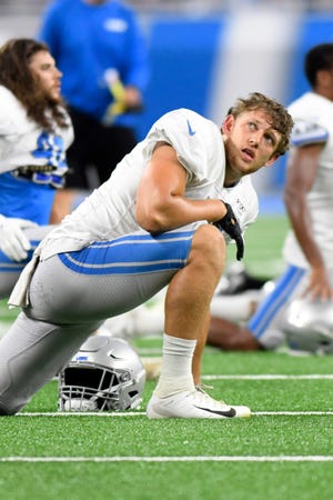 Detroit Lions tight end T.J. Hockenson stretches during the open practice session at Lions Family Fest, Friday.