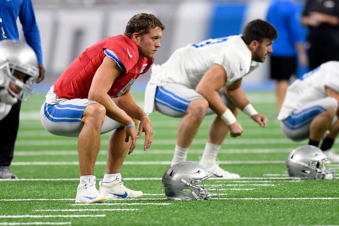 Lions quarterback Matthew Stafford, left, stretches during the open practice session at Lions Family Fest.
