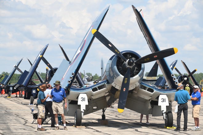 Ten vintage Vought F4U Corsairs line up on the taxi way, later taking flight over the flying enthusiasts at the Thunder Over Michigan Air Show.