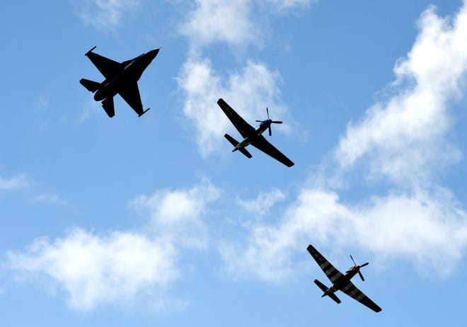 A F-16 and two P-51's fly in formation during a 'Heritage Flight.'