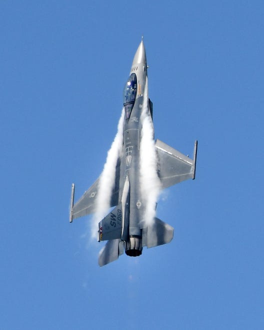 An F-16 Fighting Falcon goes skyward, climbing straight up over the crowd at the Thunder Over Michigan Air Show.