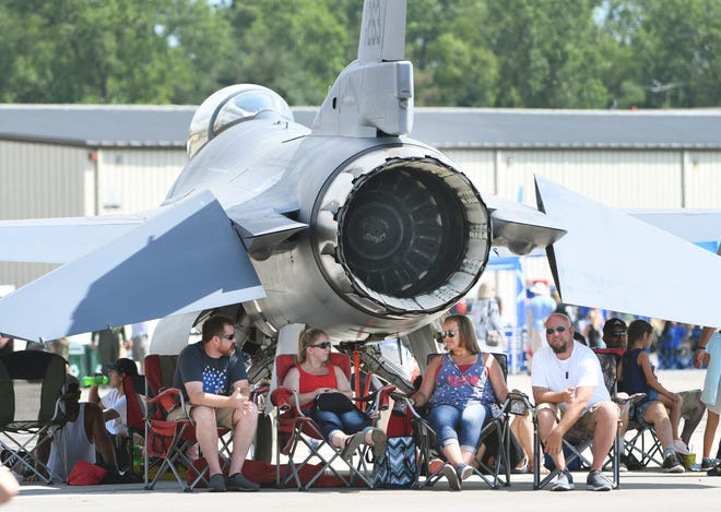 Anthony Tucker, Chelsea Glugla, Janet Rutkowski and Ryan Rutkowski under the tail section of a F-16 while watching the show.