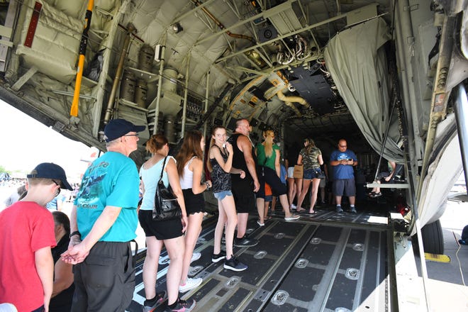 Crowds wait in line to see the inside of the huge C-130 J-Model Hercules military transport plane.