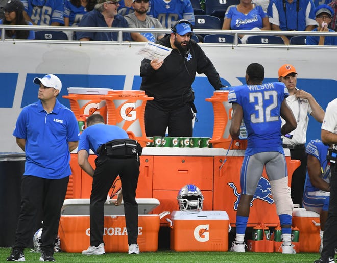 Lions head coach Matt Patricia watched from the sidelines behind a wall of Gatorade for safety due to his leg injury which limits his mobility.