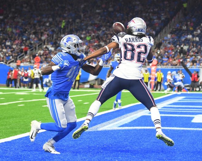Patriots wide receiver Maurice Harris catches a touchdown pass in front of Lions ' Amani Oruwariye in the first quarter.