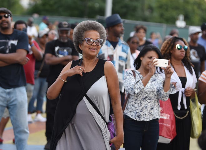 Shireen Dorsey of Cleveland, Oh, dances to the music at the Spirit of Detroit stage.