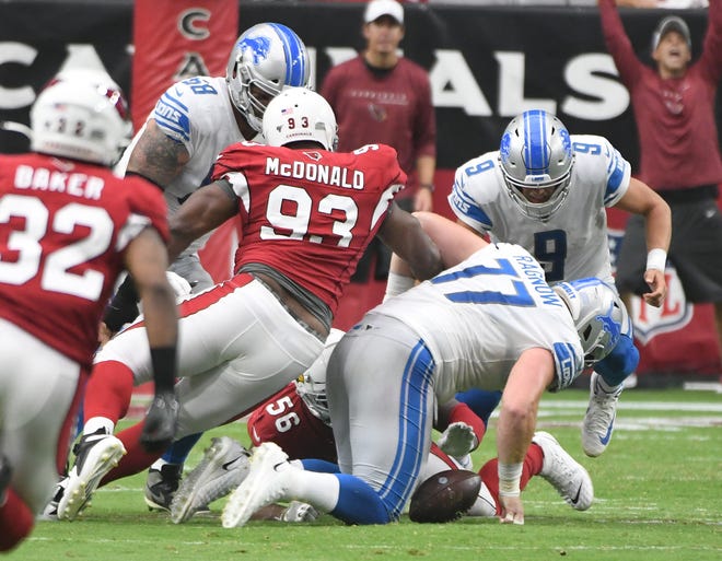 Lions quarterback Matthew Stafford fumbles the ball, but lineman Frank Ragnow is able to recover in the third quarter.