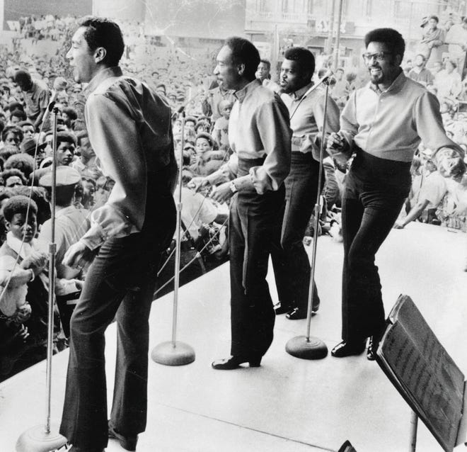 Smokey Robinson (left) and the Miracles perform in downtown Detroit in August 1969.  The Miracles produced an astounding 37 Top 40 hits for Motown, many of them written by Robinson, who is credited with writing 4,000 songs.