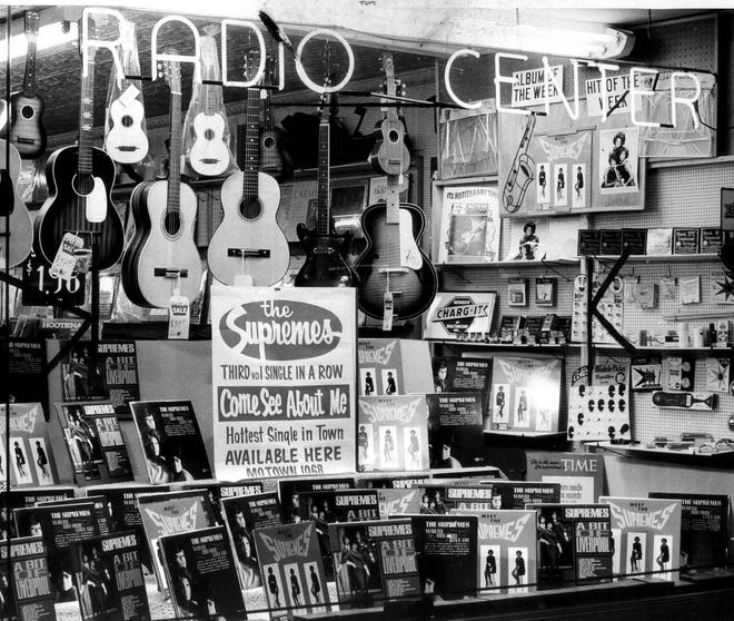 A music store displays Supremes records and a poster promoting their hit "Come See About Me," the No. 1 pop single on the Billboard chart in December 1964 and January 1965.
