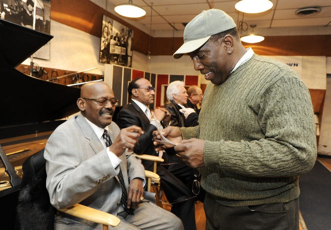 Uriel Jones, left, drummer for the Funk Brothers, looks at old photographs of his first tour out west with producer, writer and engineer Clay McMurray in Studio A at the Motown Museum in Detroit on Jan. 12, 2009. Many people involved with Motown Records were on hand for visitors to talk to during the tour.