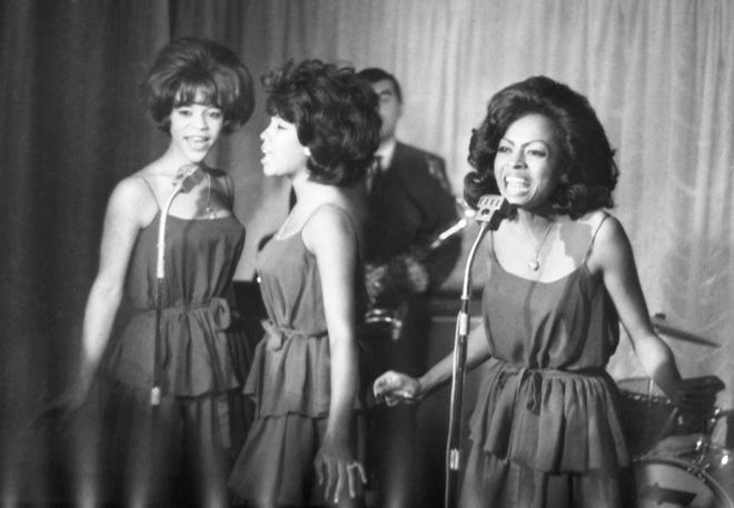 The Supremes perform in London on Oct. 8, 1964, after "Where Did Our Love Go" became their first single to go No. 1 on the charts. This was before adopting their ultraglamorous look favoring full-length sequined gowns. From left are Florence Ballard, Mary Wilson and Diana Ross.
