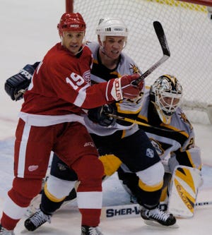 Greg Johnson, playing for Nashville, battles Steve Yzerman in front of the net during a game in 2004.