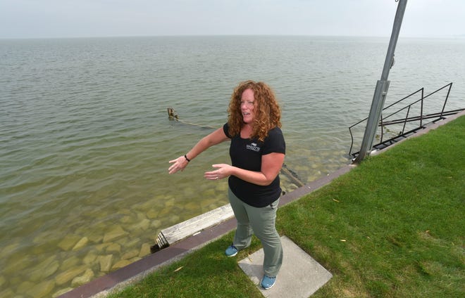 Killarney Beach resident Julie Schultz of Bangor Township talks about the rising waters of Saginaw Bay as she stands on the seawall behind her house. She says her beachfront was three times larger when she and her family moved here years ago.