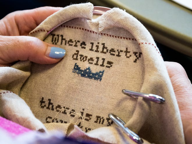 Embroidery Guild Vice President Deborah Shoop of Farmington Hills works on a patriotic piece.