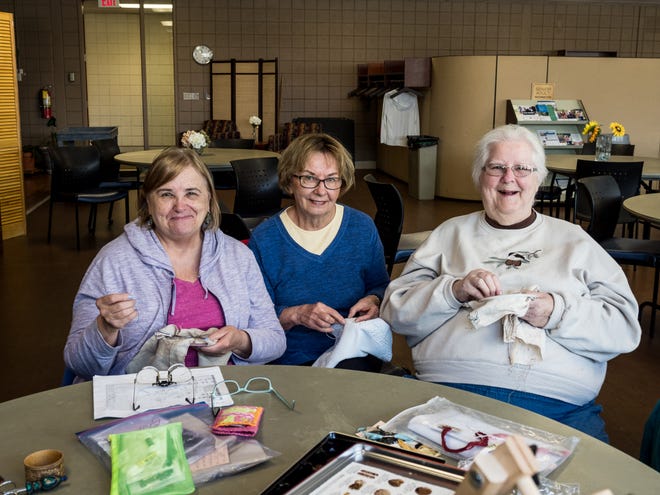 Embroidery Guild members (from left) Vice President Deborah Shoop, former Secretary Pat Walny and President Beverly Weidendorf, all of Farmington Hills, enjoy some time together working on their embroidery projects.