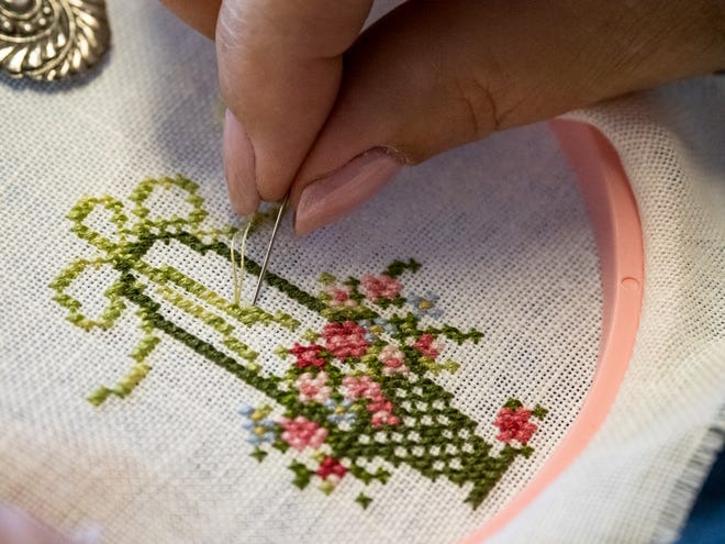 Cindy DeHart of Ann Arbor works on an Embroidery Guild project.