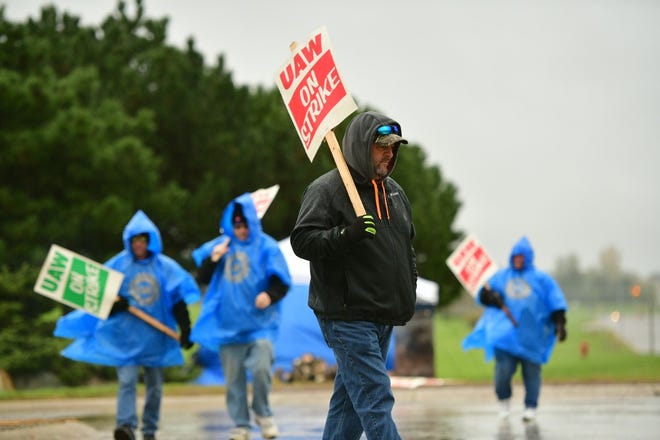UAW Local 5960 workers walk the line at the GM Lake Orion assembly plant.