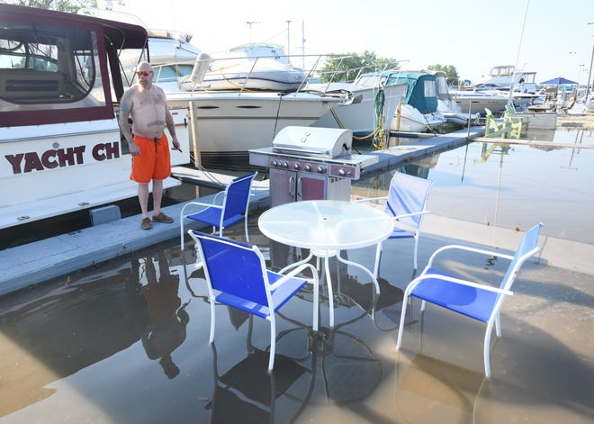 Willie Brown enjoys some time at his boat in the Humbug Marina in Gilbraltar on July 1, 2019, but found  his table, chairs and grill in water in the parking lot.