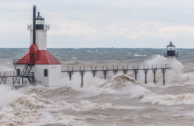 Large waves on Lake Michigan, caused by high winds, crash into the St. Joseph Lighthouse and pier on Oct. 16, 2019, in St. Joseph.