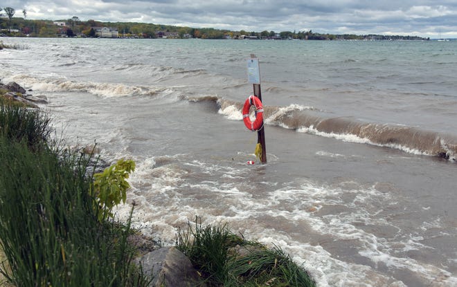West End Beach in Traverse City is completely under water on Oct. 16, 2019, with severe erosion in the parking area. The life buoy is usually several feet from the water on the beach.