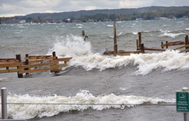 High winds in Grand Traverse Bay, fed by Lake Michigan, pushed near-record-high water onto the pier at the West End Beach-Holiday Inn in Traverse City, on Oct. 16, 2019. The hotel also had flooding in its parking lot.