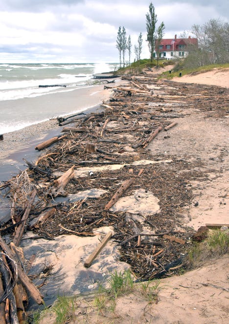 Piles of woody debris lie on the beach at Point Betsie Lighthouse in Benzie County on Oct. 16, as high winds on Lake Michigan swept ashore high water.