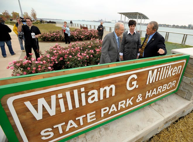 Former Michigan Gov. William Milliken;  Becky Humphries, director of the Michigan DNR, and Keith Charters of the Natural Resources Commission, chat in front of one of the signs naming the park in Milliken's honor, October 22, 2009.