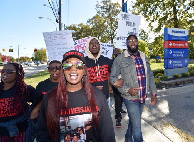 Paige White, center, marches with, her mother, Martha Chambers, left, sister Chanelle White, brother, Joseph White and Pastor K.C. Pierce, III, in front of Beaumont Hospital on Oakwood. Pierce is pastor of Hopewell Baptist Church and chairman of religious affairs for the NAACP-Detroit Branch.
