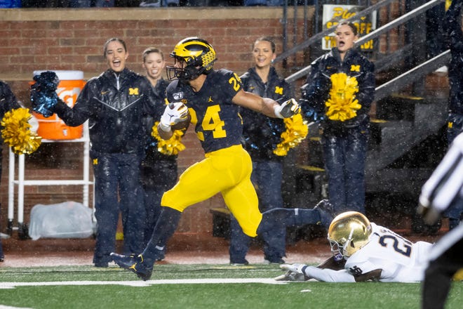 Michigan running back Zach Charbonnet is tripped up by Notre Dame safety Jalen Elliott just outside of the end zone in the first quarter.