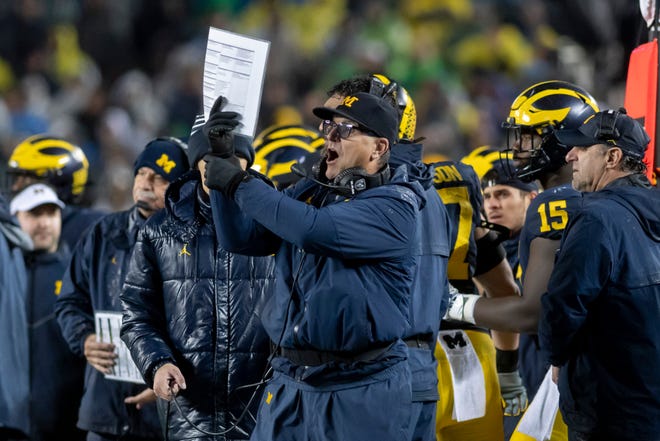 Michigan head coach Jim Harbaugh tries to convince the officials to call a holding penalty in the fourth quarter.