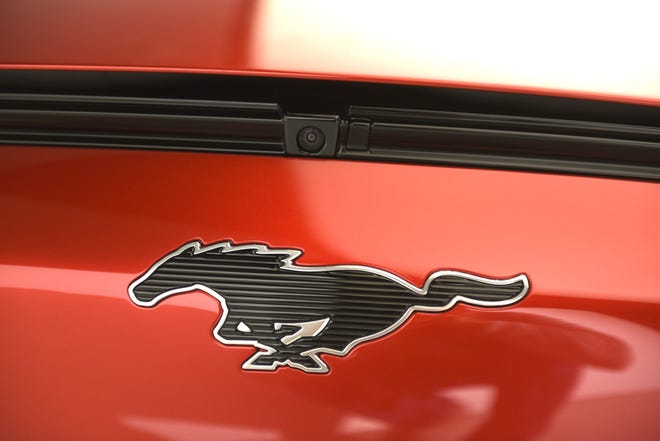 Mustang’s familiar pony emblem is stretched horizontally and detailed — not with a horse’s sinewy contours, but with a ribbed, techie surface. The logo on the GT performance model will be lighted in white.