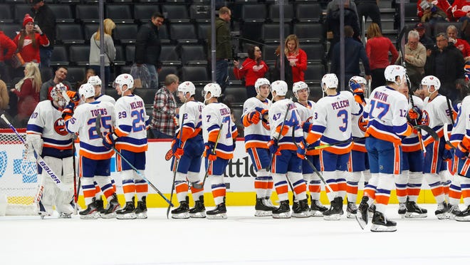 New York Islanders players celebrate their 4-1 win against the Detroit Red Wings.