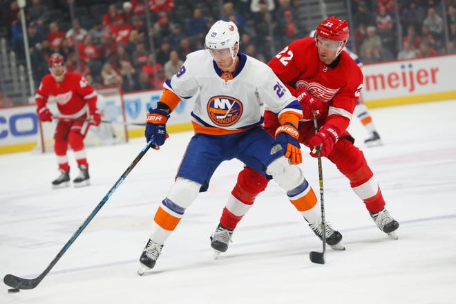 New York Islanders center Brock Nelson (29) protects the puck from Detroit Red Wings defenseman Patrik Nemeth (22) in the first period.