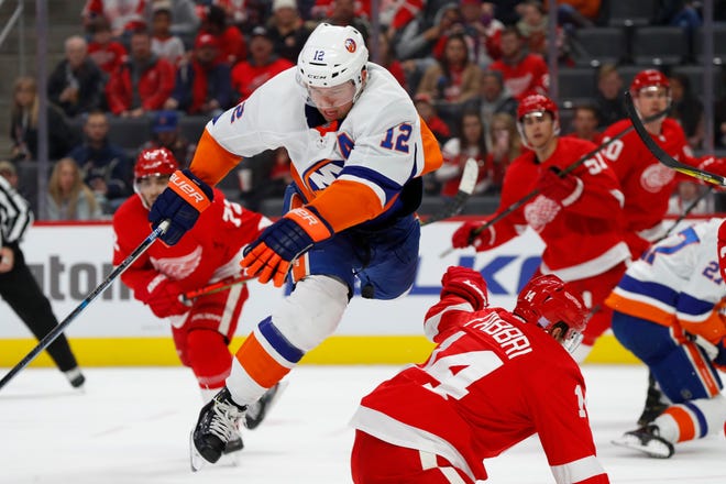 New York Islanders center Josh Bailey (12) is checked by Detroit Red Wings center Robby Fabbri (14) in the first period.