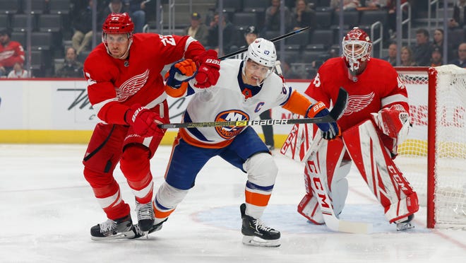 Detroit Red Wings defenseman Patrik Nemeth (22) and New York Islanders center Anders Lee (27) battle for position in front of goaltender Jonathan Bernier (45) in the first period.