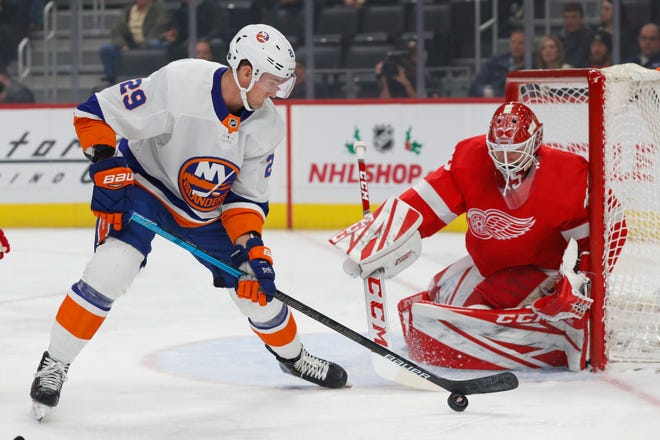 New York Islanders center Brock Nelson (29) tries to shoot against Detroit Red Wings goaltender Jonathan Bernier (45) in the first period of an NHL hockey game Monday, Dec. 2, 2019, in Detroit.