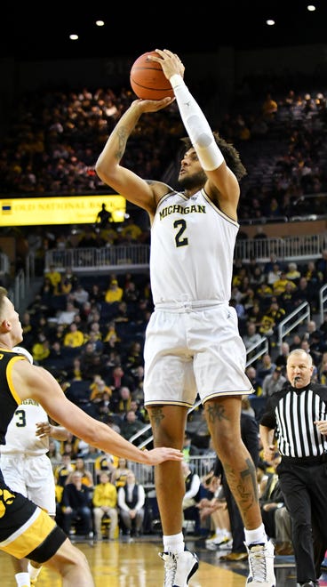 Michigan forward Isaiah Livers (2) takes a three-point shot  in the first half.