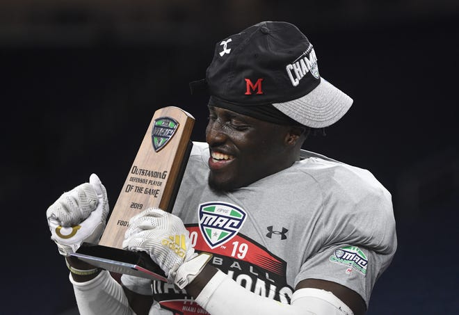 2019 MAC Championship defensive player of the game defensive back Emmanuel Rugamba celebrates on stage after the victory over Central Michigan.
