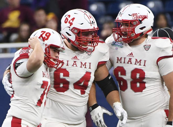 Miami's Samuel Sloman celebrates with David Redding and Donovan White after Sloman's field goal to go up 9 late in the fourth quarter.