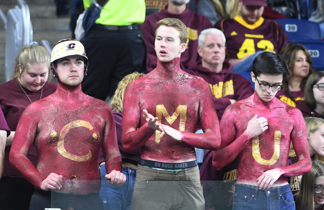 All dressed up and no where to go as three Chippewa fans watch Centrla Michigan fall to Miami, 26-21 in the MAC Championship.