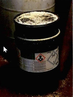 50-kilogram cyanide container, with powder or crystals on container surface