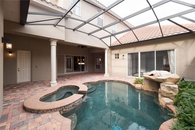 The home includes a screened-in courtyard, saltwater pool and spa, and a lanai.
