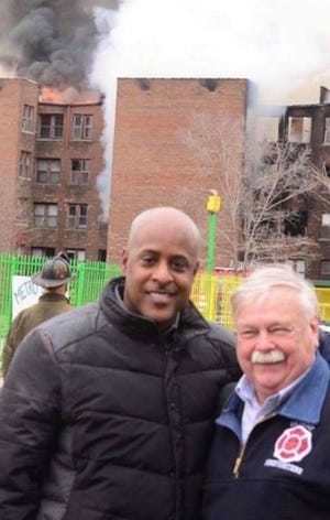 Detroit Fire Commissioner Eric Jones and Deputy Fire Commissioner Dave Fornell allegedly pictured in front of a burning building on an undisclosed date
