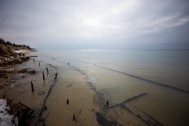 The remainder of what was once three retaining walls can be seen covered by water along the Lake Michigan shoreline in Shelby, Mich. Dawn Mendenhall of Oregon said, "Six years ago we were having a bonfire out there." Mendenhall grew up at the property.