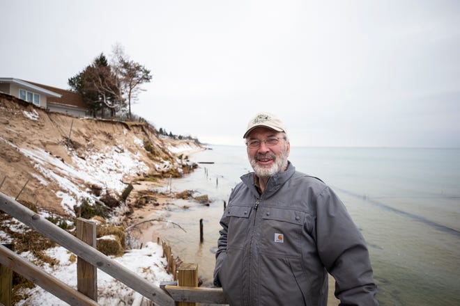 Phil Jonassen of Jonassen Inc. Structural Movers stands along the eroded Lake Michigan shoreline  in Shelby, Mich. where his company is working to move several houses that are threatened by the eroding bluffs.
